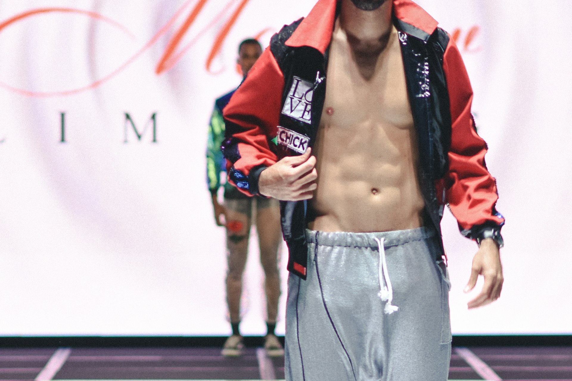 man in red leather jacket and gray pants